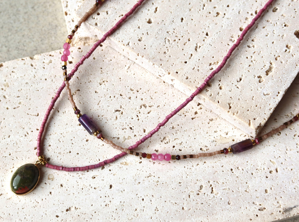 Necklace with a green pendant on purple natural stone