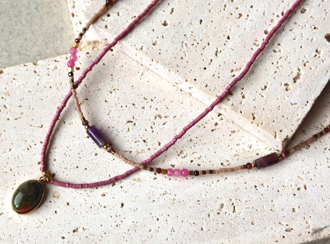 Necklace with a green pendant on purple natural stone